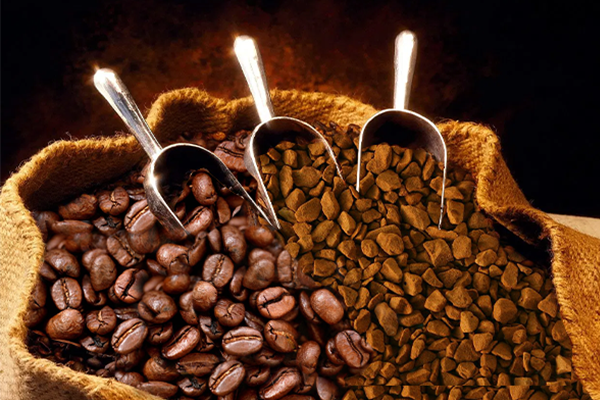 A sack of coffee beans and micro ground coffee beans with three scoopers placed within the sack.