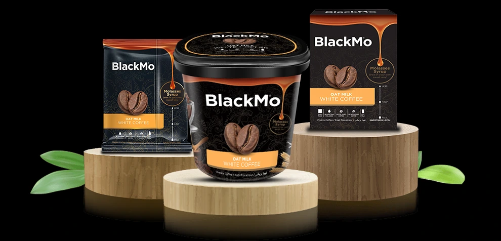 BlackMo’s White Coffee tub, box and sachet packaging in full display on wooden platforms.